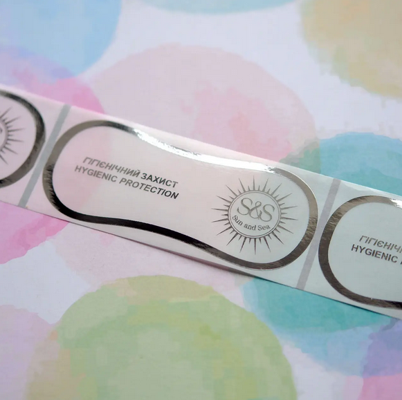 Гігієнічні наклейки сліп, 45х110мм, з логотипом (срібло), прозора плівка в рулоні